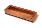 A Blackwing Flat Box Display with a black stripe, containing a Blackwing pencil.